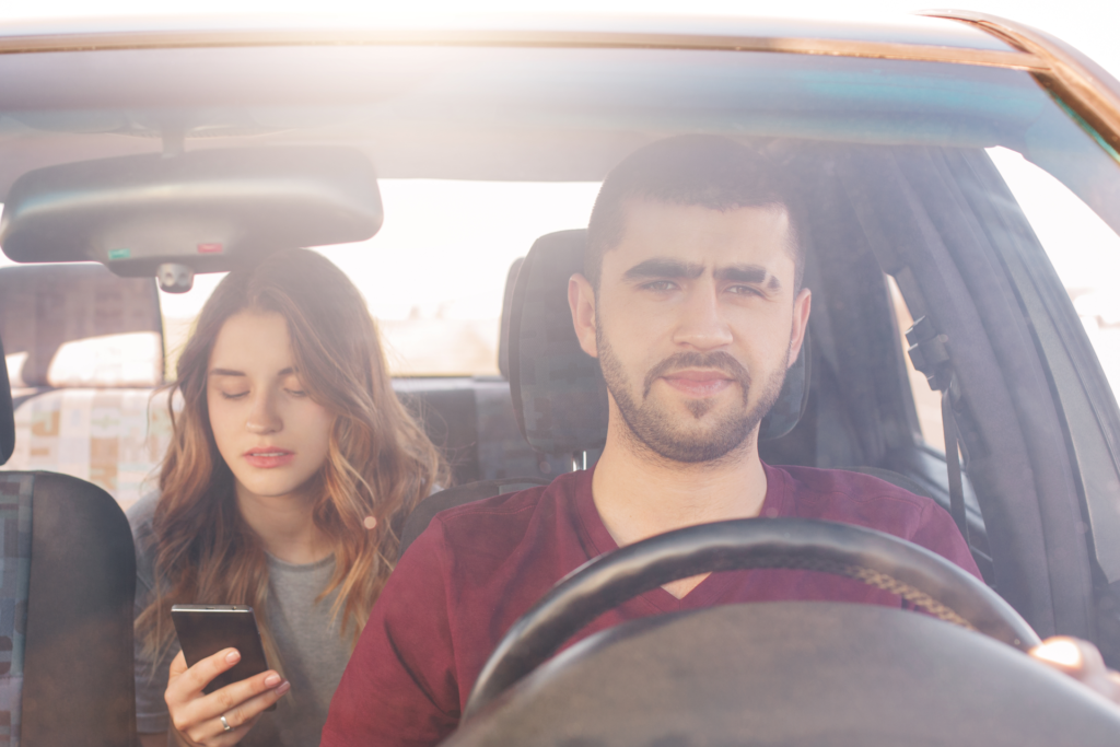 A male driver transporting a female passenger in a rideshare.