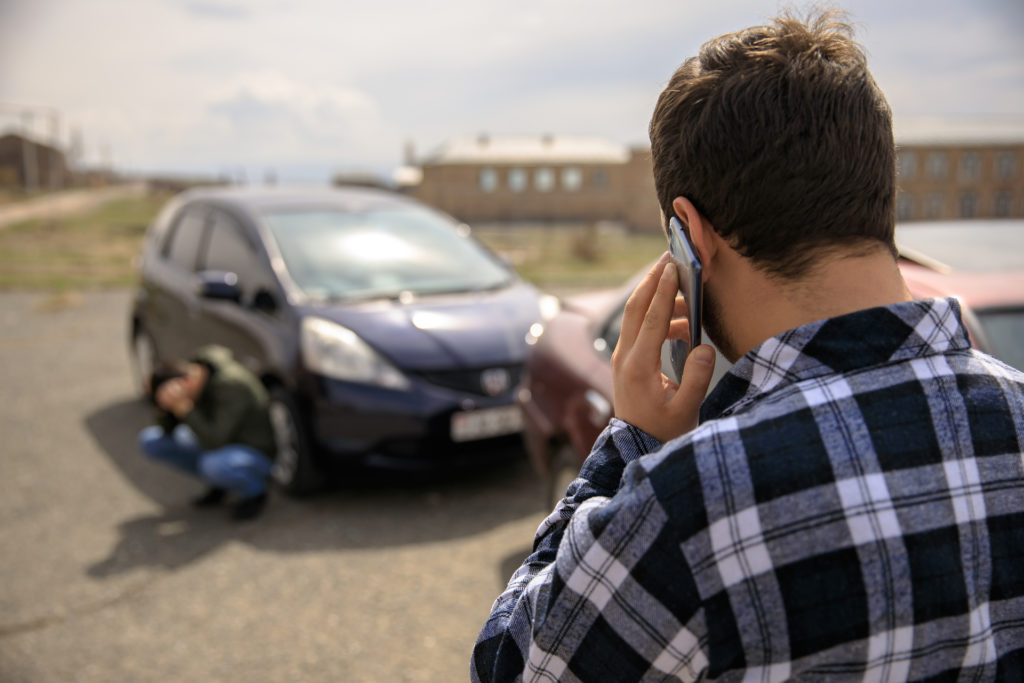 Man calling lawyers after car wreck.